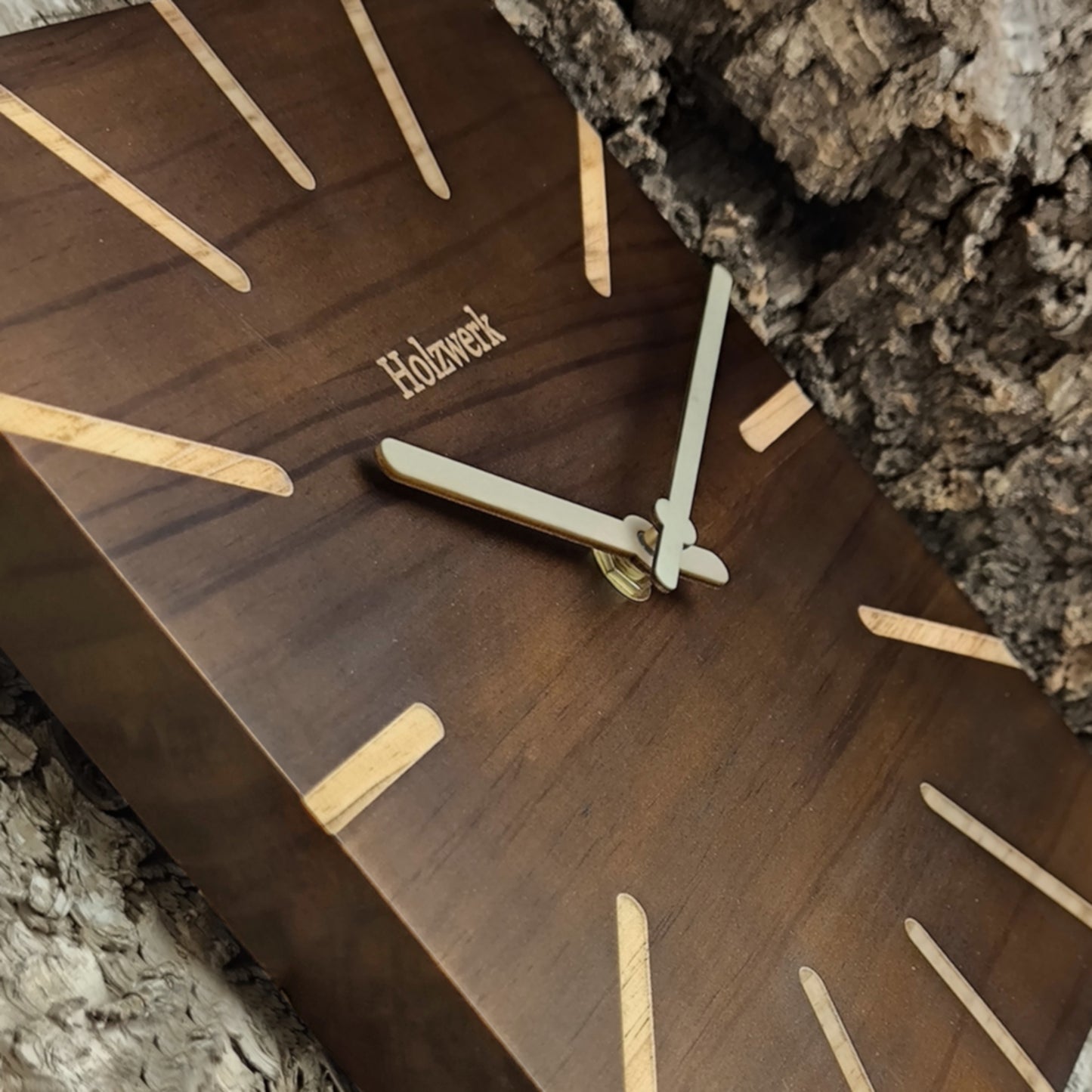 Schrägaufnahme der Holzwerk HERZBERG 25 cm Wanduhr aus Vollholz mit modernem Design und hölzerner Zeigerführung